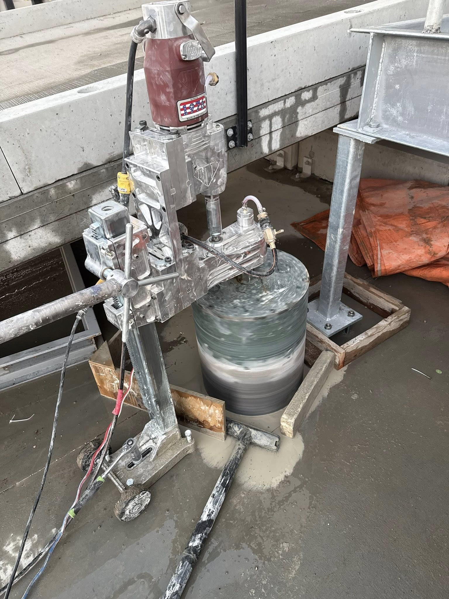 Concrete core drilling equipment set up for precision drilling at night