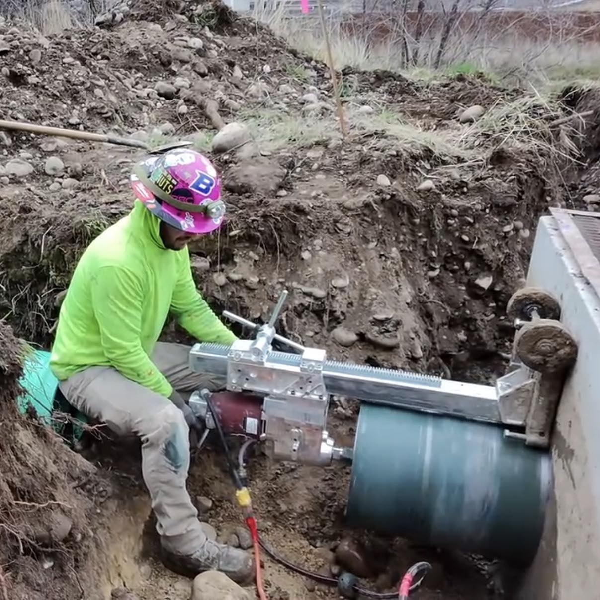 Concrete core drilling equipment working outdoors in a utility access area