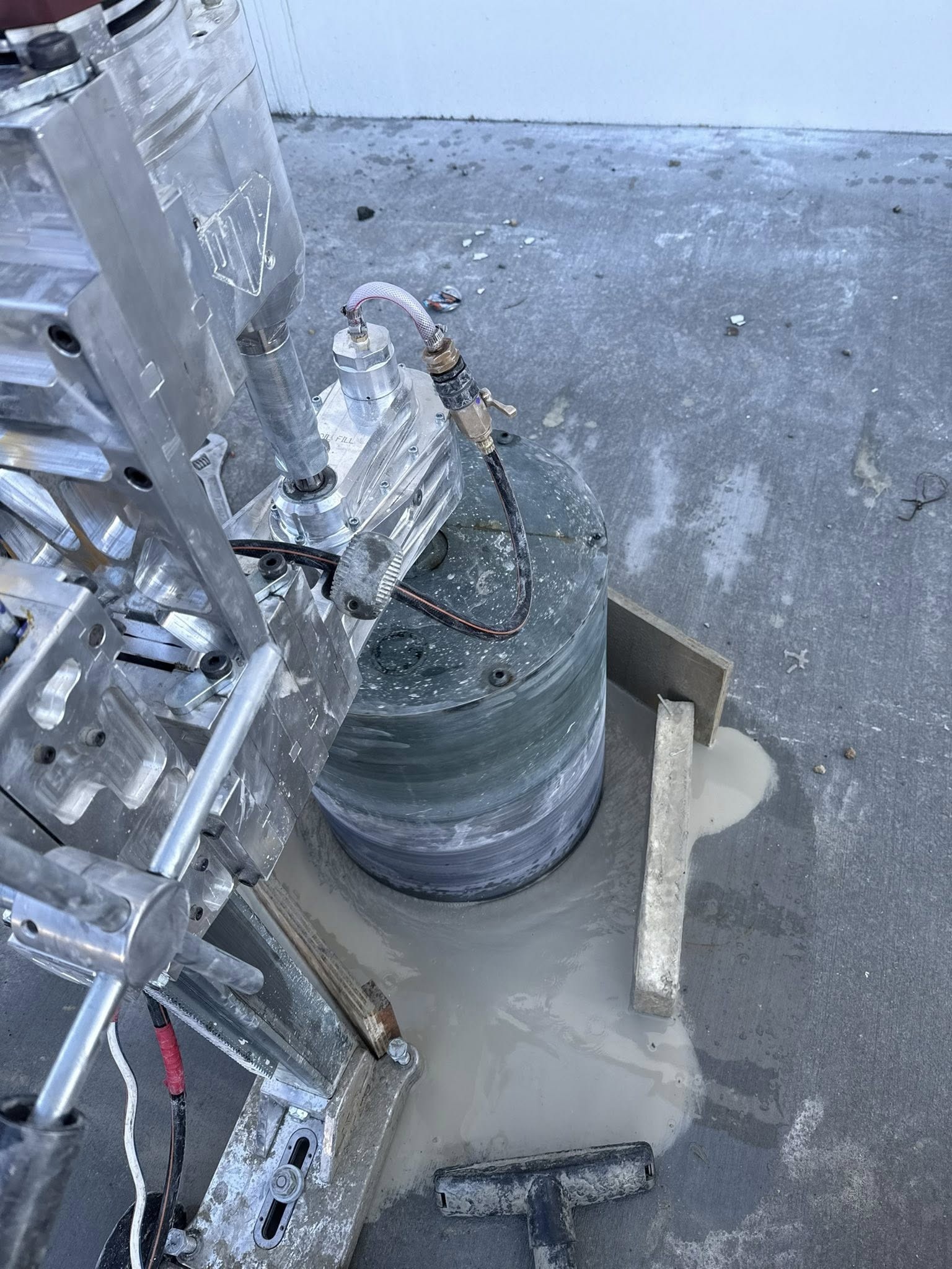 Large diameter concrete core being drilled with water control