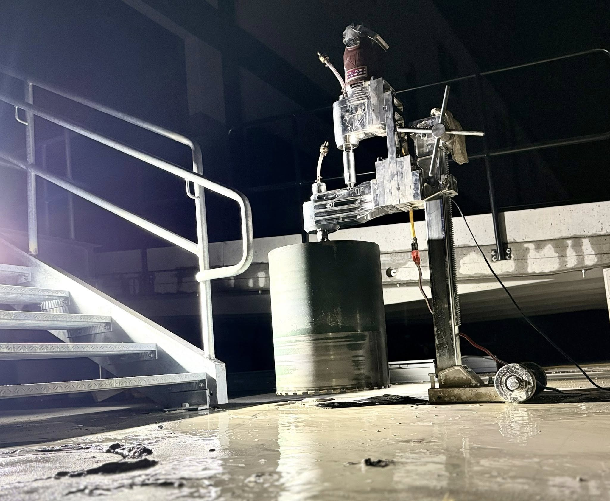 Concrete core drilling equipment cutting a smaller core opening